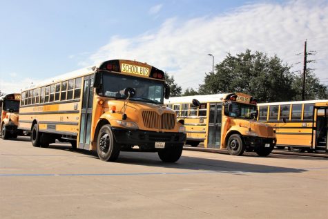 The Westside bus parking lot waits for the afternoon bell to ring.